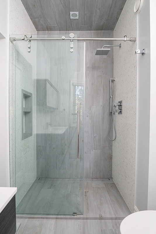 Sleek walk in shower with sliding glass door - Bathroom renovation